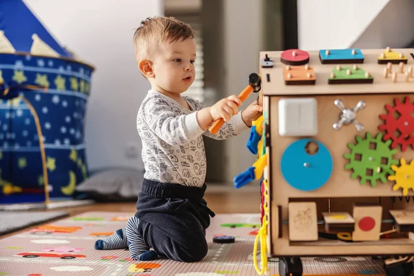 Adorable toddler playing interactive games for good development at home.