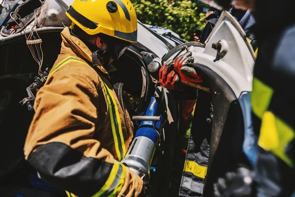Firemen Crouching Crashed Car Fire Trying Flip — Stock Photo, Image
