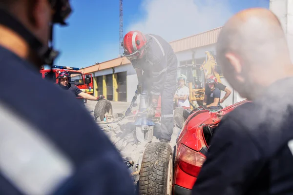 Firefighter Standing Top Crashed Car Trying Release Man Car — Stock Photo, Image