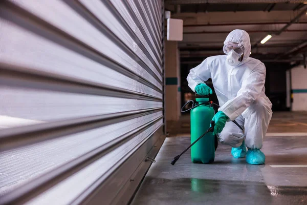 Man Protective Sterile Uniform Crouching Disinfecting Garage Disinfectant — Stock Photo, Image