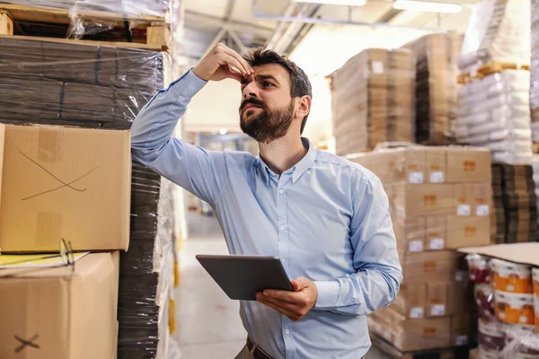 Nervous Young Attractive Bearded Businessman Leaning Box Warehouse Holding Tablet — Stock Photo, Image