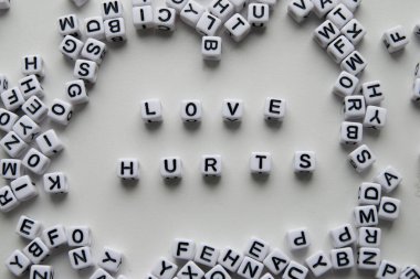 love hurts word written on cubes on white background. Creative text for your business. Chaotic letters design clipart