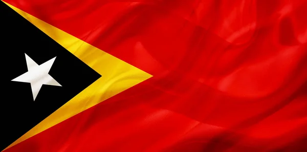 East Timor country flag on silk or silky waving texture — Stock Photo, Image