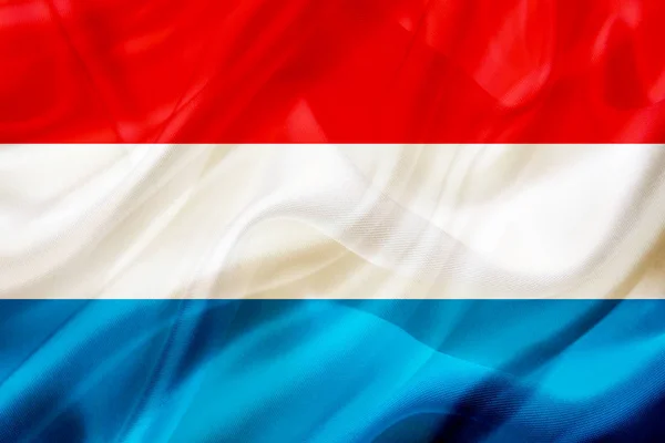 Vlajka země Lucemburska na hedvábí nebo hedvábná mávající textura — Stock fotografie