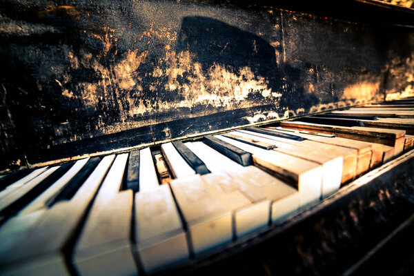Broken grunge old piano keys close up