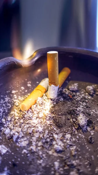 Estinguished cigarettes buds on an ashtray close up — Stock Photo, Image