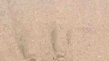 4k video Kumlu sahil veya okyanusta ezici veya sıçrayan çok sakin dalgaların görünümünü kapatın 