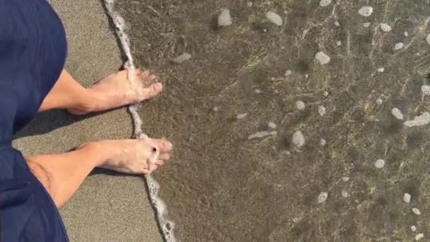 Мужские Ноги Камнем Спокойные Волны Дробления Брызги Песчаном Берегу — стоковое видео