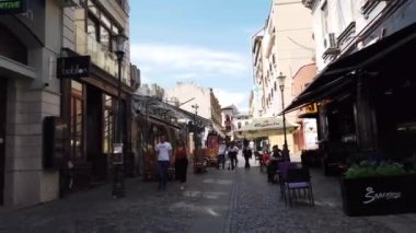 Bükreş, Romanya - 20 Haziran 2020: 4 km uzunluğunda Romanya 'nın Bükreş kentindeki Old Town veya Old Center' da yürüyüş videosu. Lipscani sokağı insanlarla yürüyor, eski mimari, teraslarda tatil yapan insanlar.