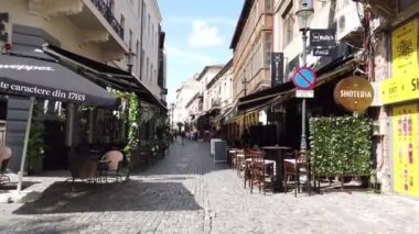 Bükreş, Romanya - 20 Haziran 2020: 4 km uzunluğunda Romanya 'nın Bükreş kentindeki Old Town veya Old Center' da yürüyüş videosu. Lipscani sokağı insanlarla yürüyor, eski mimari, teraslarda tatil yapan insanlar.