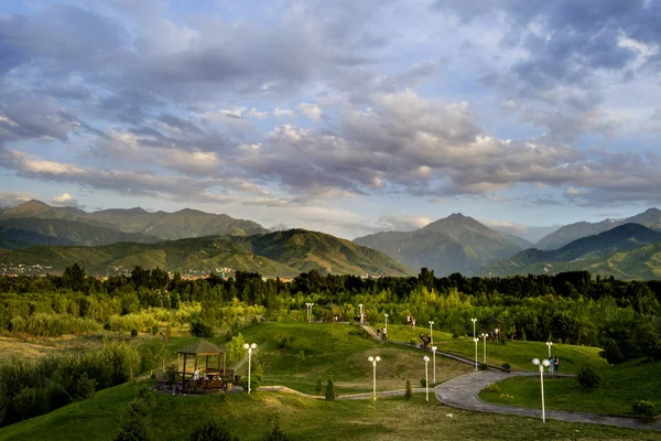 Beautiful park with road and lamp posts in Almaty, Kazakhstan