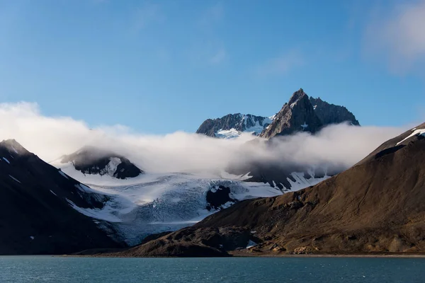 Rock with snow in sea