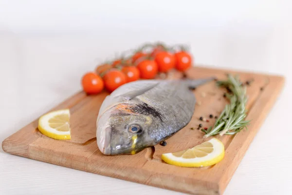 Pesce Dorado Fresco Con Pomodorini Rosmarino Limone Pepe Sul Tagliere — Foto Stock