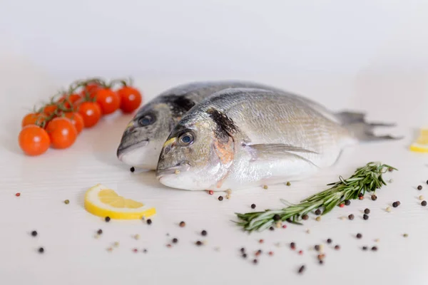 Due Pesci Dorada Freschi Con Pomodorini Rosmarino Limone Pepe Fondo — Foto Stock