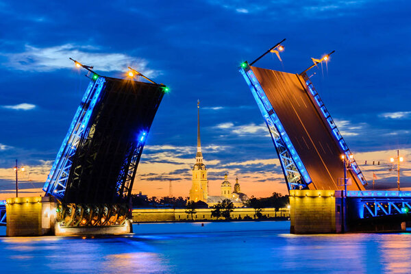 Opened bridge in Saint-Petersburg at white night with view to Peter and Paul fortress