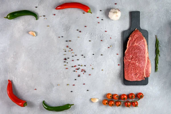 新鲜的大理石肉和调味品在灰色背景的顶部视图 — 图库照片