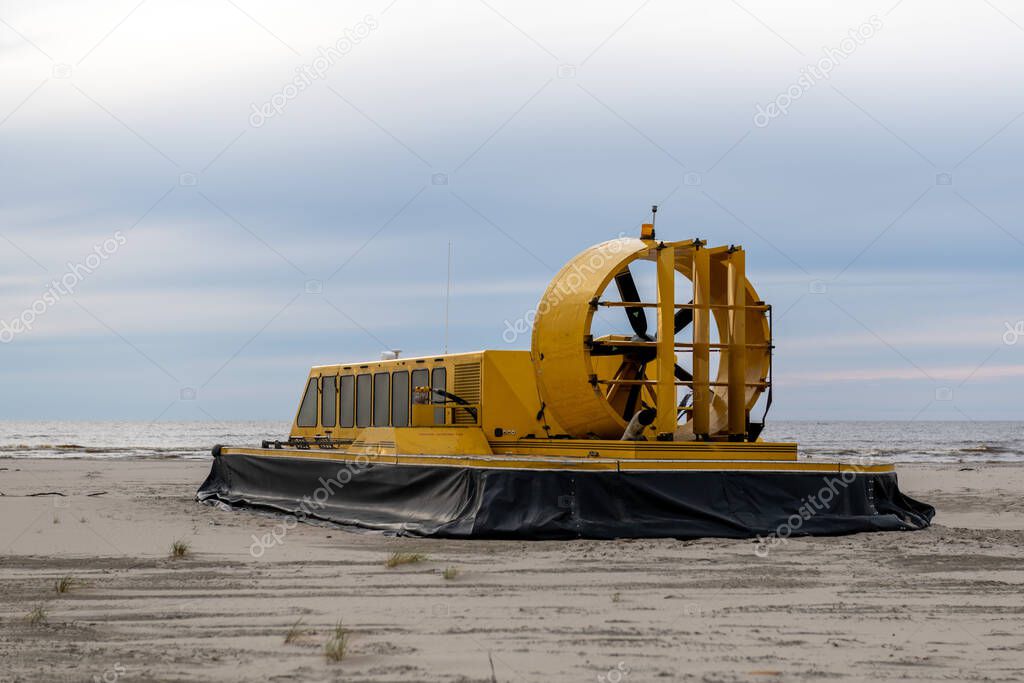 Yellow hovercraft on the sand beach close up