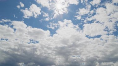 Çarpıcı bir zaman çizelgesi. Güneş bulutların arasından parlak mavi gökyüzüne doğru parıldıyor..