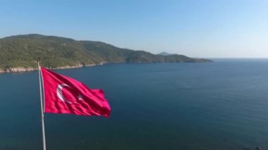 Türkiye bayrağı denizin arka planında rüzgarda dalgalanıyor. Hava görünümü.