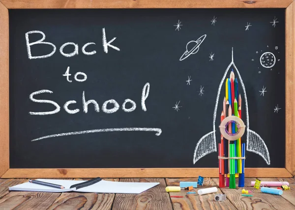 Back to School Concept with Hand Drawn Rocket on Blackboard