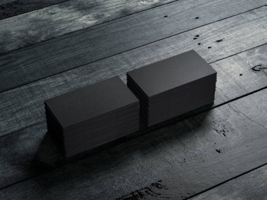 Ahşap zeminde iki paket siyah kartvizit. 3d oluşturma