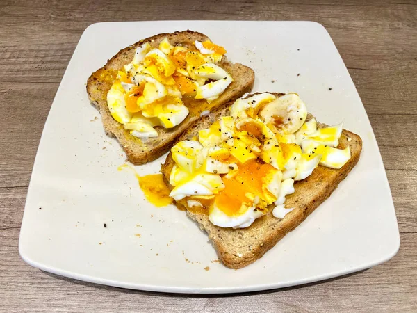 Soft boiled Duck Eggs, sliced and placed on buttered brown toast