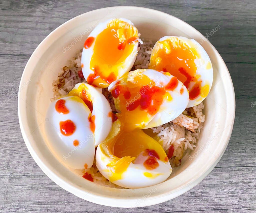 Soft boiled Duck Eggs, sliced and placed on savoury onion rice with chilli sauce, a taste of Asia