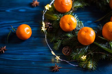 Yaprakları ile taze mandalina ve koniler garland ve anasonu Donanma rustik ahşap tablo ile çam dalları yapılan çelenk. Noel narenciye dekorasyon.