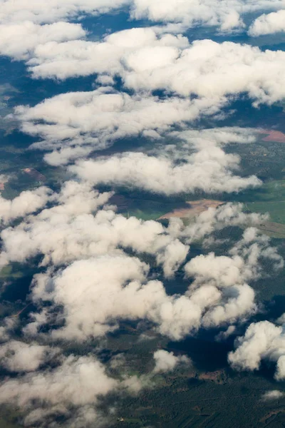 white and colored clouds from airplane