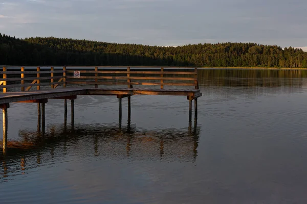 wooden footbridge on calm beautiful river