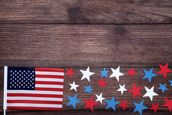 American flag with paper stars on wooden table