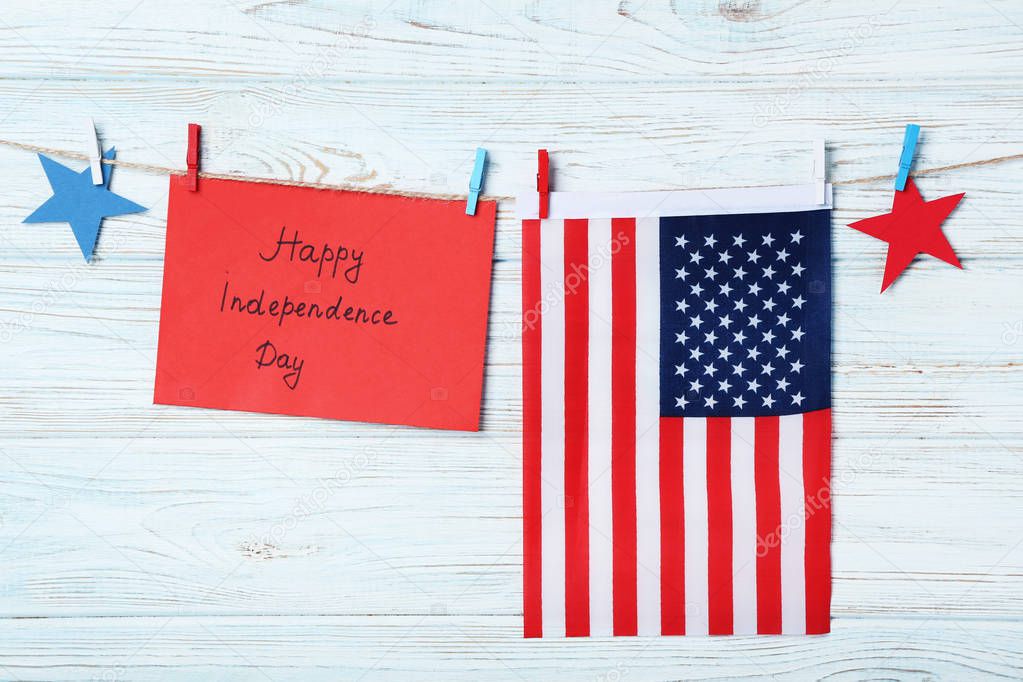 American flag and paper with inscription Happy Independence Day