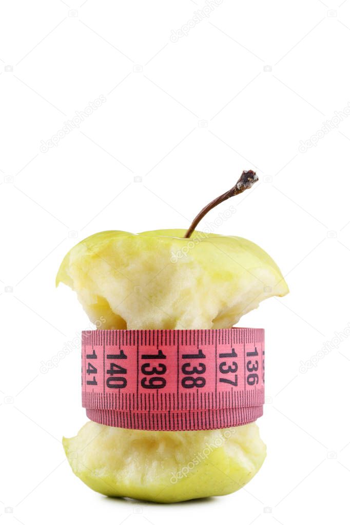 Green apple with measuring tape on white background