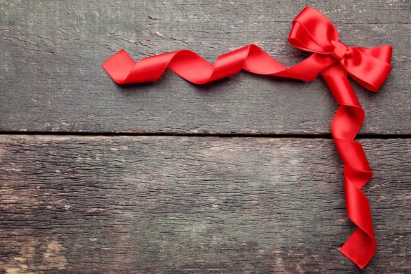 Red Bow Ribbon Grey Wooden Table — Stock Photo, Image