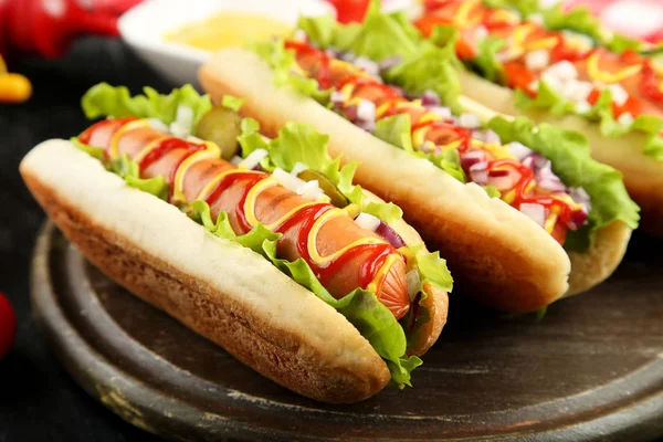 木桌上加番茄酱 芥末和蔬菜的热狗 — 图库照片