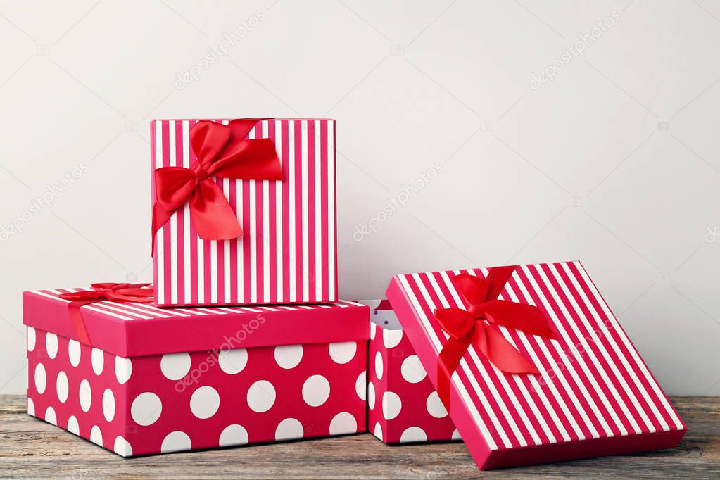 Gift boxes with ribbon on grey wooden table