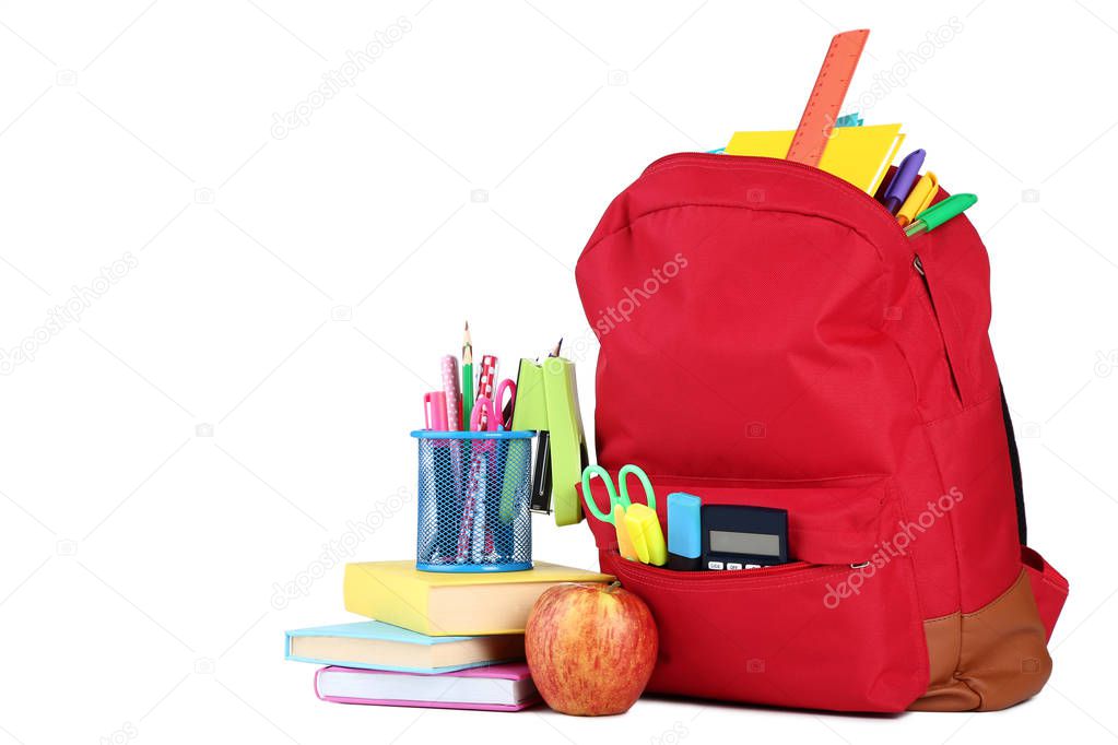 Red backpack with school supplies on white background