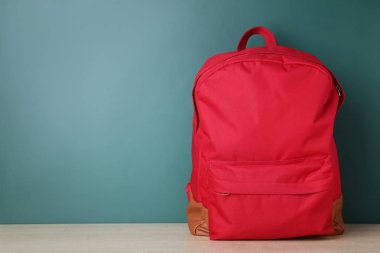 Yeşil zemin üzerine kırmızı okul sırt çantası
