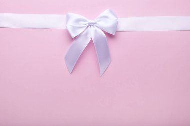 Yay ile şerit pembe bir arka plan üzerinde beyaz