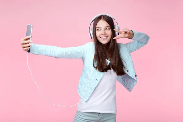 Jong Meisje Met Hoofdtelefoons Smartphone Roze Achtergrond — Stockfoto