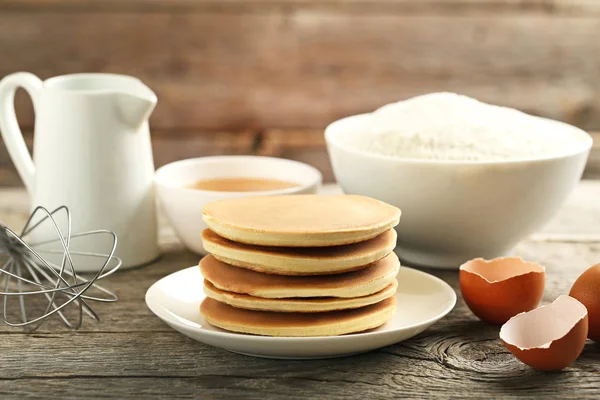 Tasty Pancakes Eggs Flour Cup Tea Grey Wooden Table — Stock Photo, Image
