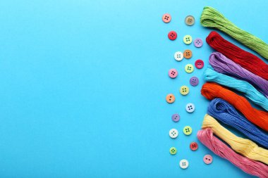 Konu mavi arka plan üzerinde renkli dikiş düğmeleri