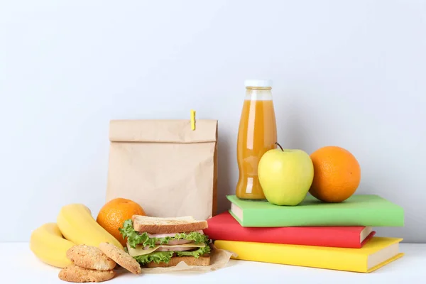 Almuerzo Escolar Con Bolsa Papel Libros Sobre Fondo Gris — Foto de Stock