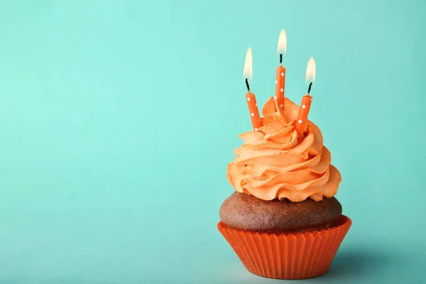ミントの背景に蝋燭とおいしいカップケーキ — ストック写真
