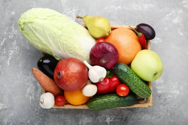 Ripe fruits and vegetables in basket on grey wooden table — Stock Image Ripe Fruits Vegetables Basket Grey Wooden Table Stock Photo