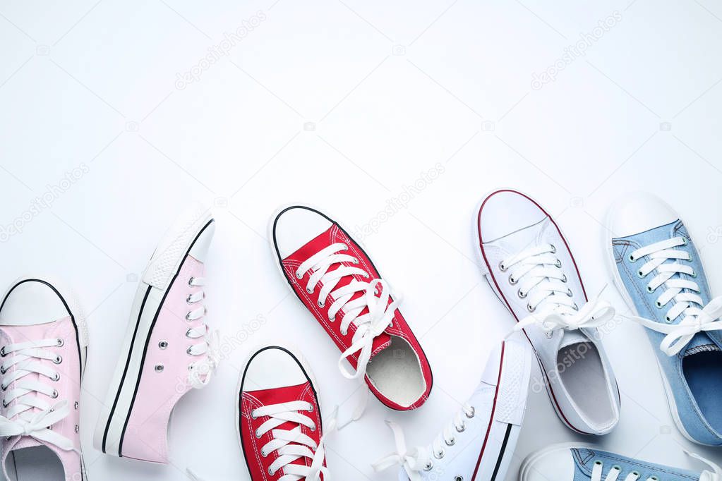 Different colorful sneakers on white background