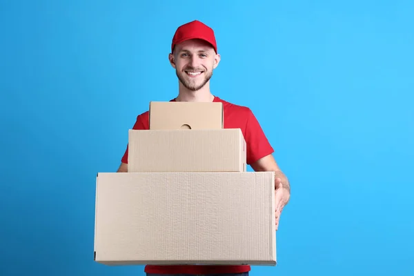Delivery Man Holding Pile Cardboard Boxes Blue Background — Stock Photo, Image