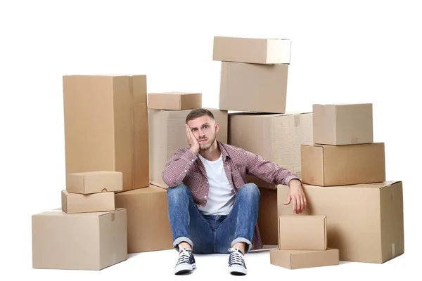 Joven Hombre Con Cajas Cartón Sentado Suelo Sobre Fondo Blanco — Foto de Stock