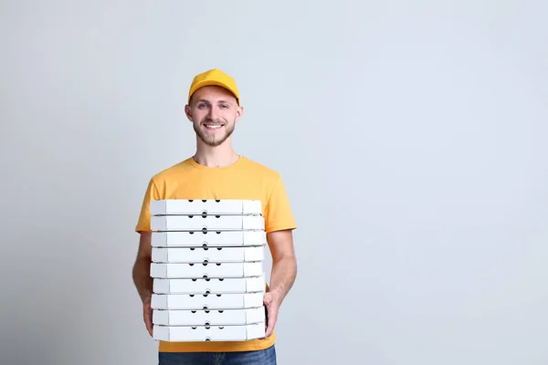 Leverans Man Håller Pizzakartonger Grå Bakgrund — Stockfoto