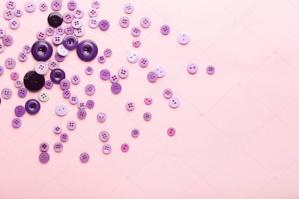 Purple sewing buttons on pink background